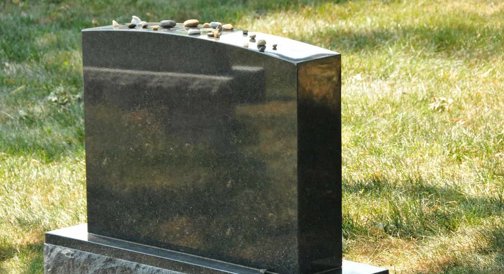 Burial polished granite headstone at grave