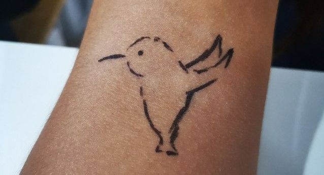 Small memorial tattoo of a hummingbird
