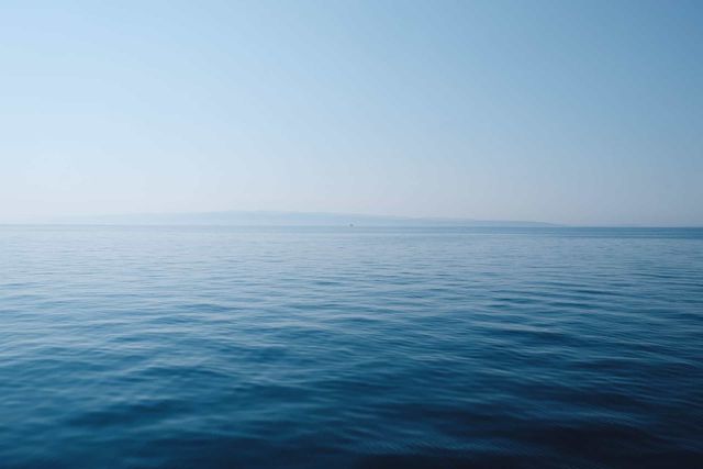 sea burial location - an expanse of blue sea with a blue sky overhead