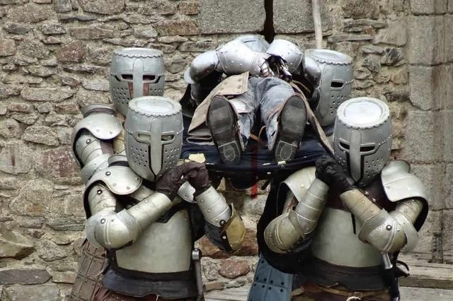 Knights carrying out a funeral.