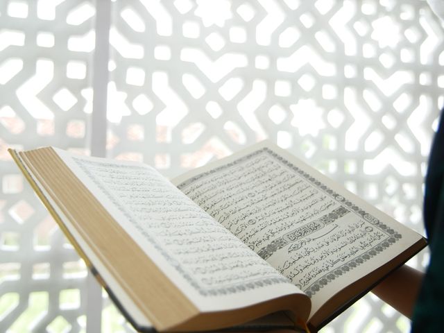 A person reading from the Quran at a mosque.