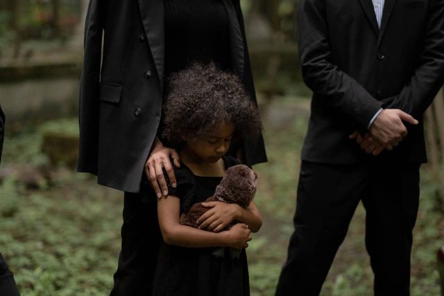 A child attending a funeral.