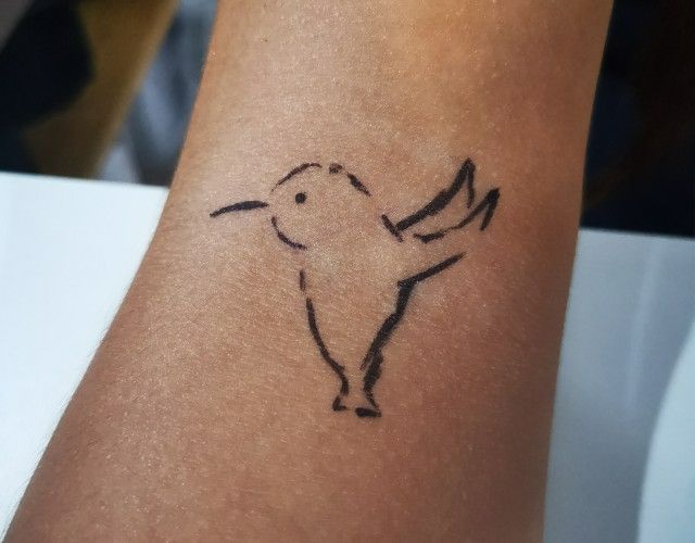 Small memorial tattoo of a hummingbird