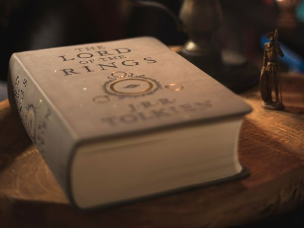 Hardback book of Lord of the Rings on a wooden table in warm light