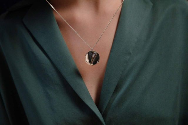 Memorial necklace and pendant around woman's neck.
